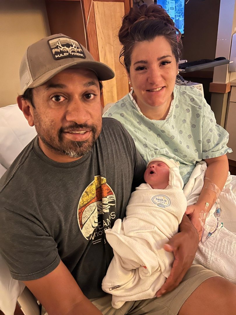 Mother and father in the hospital hold their new baby