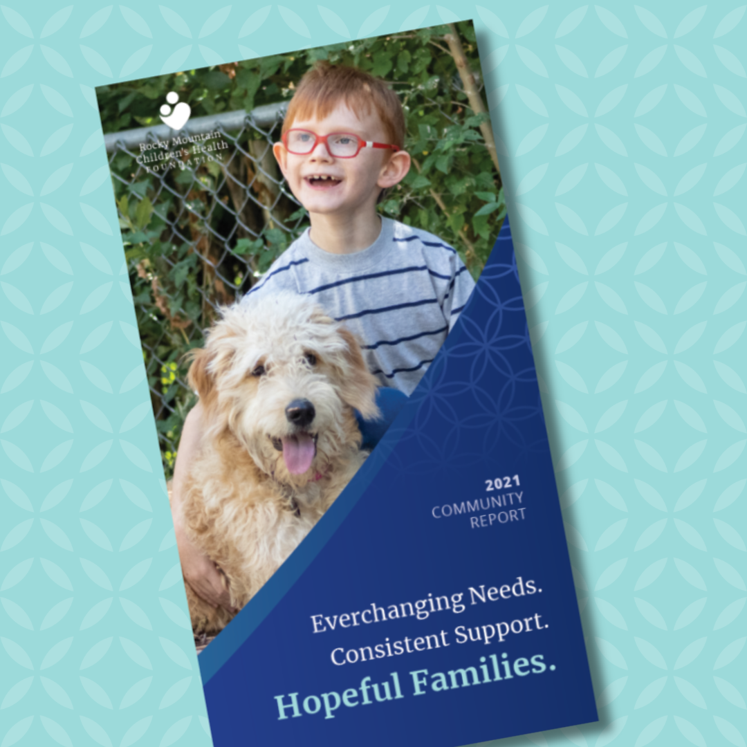 a community report laying at an angle on a teal backdrop. the community report has a photo of a young boy and a dog on the front.